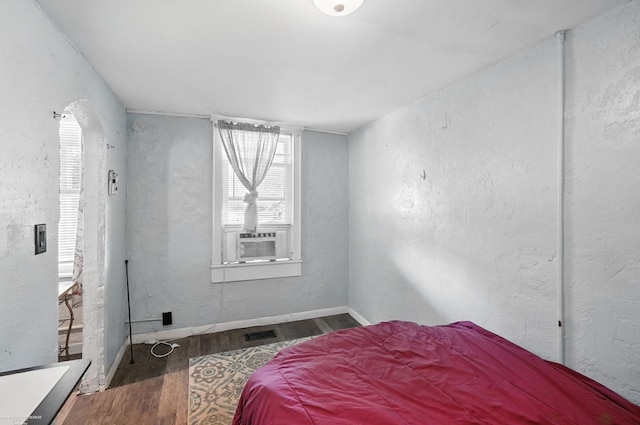 618 Harrison St, Monroe, MI 48161 - bedroom featuring wood finished floors, cooling unit, and a textured wall