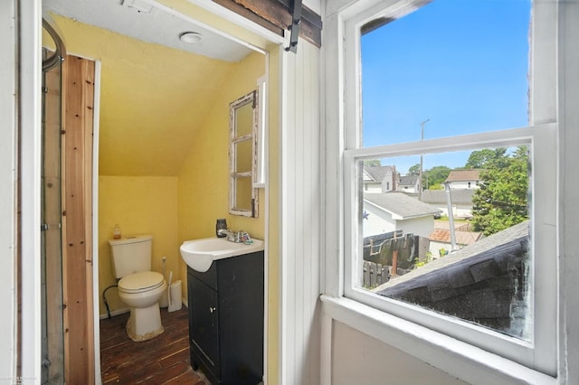 618 Harrison St, Monroe, MI 48161 - half bath featuring vanity, lofted ceiling, and wood-type flooring
