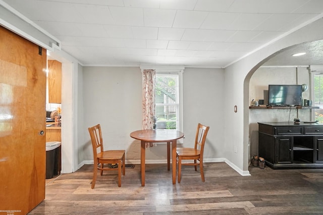 618 Harrison St, Monroe, MI 48161 - dining area featuring wood finished floors, arched walkways, and crown molding