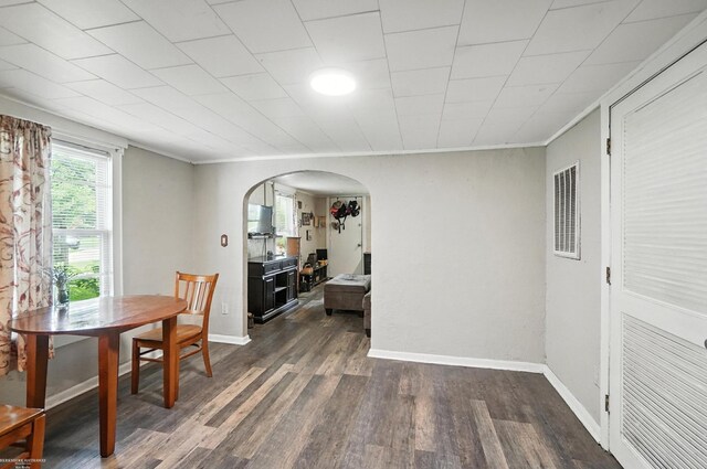 618 Harrison St, Monroe, MI 48161 - dining space with arched walkways, dark wood-style floors, and crown molding