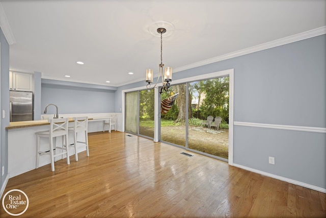 870 Crescent Ln, Grosse Pointe Woods, MI 48236 - unfurnished dining area featuring a chandelier, ornamental molding, wood finished floors, and recessed lighting