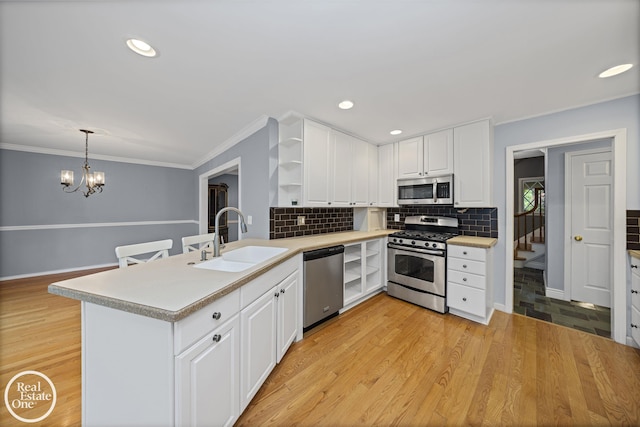 870 Crescent Ln, Grosse Pointe Woods, MI 48236 - kitchen with stainless steel appliances, open shelves, light countertops, ornamental molding, and white cabinetry