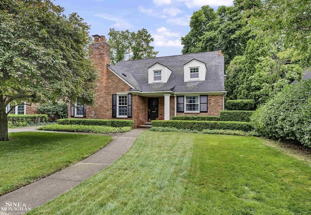 388 Lincoln Rd, Grosse Pointe, MI 48230 - new england style home with brick siding, a chimney, and a front yard