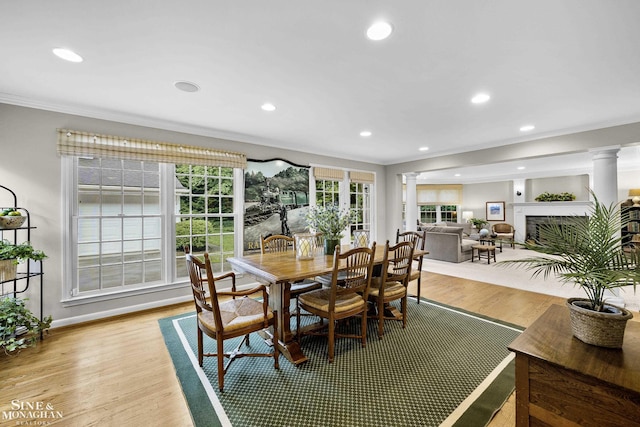388 Lincoln Rd, Grosse Pointe, MI 48230 - dining space with decorative columns, ornamental molding, a fireplace, recessed lighting, and light wood-type flooring