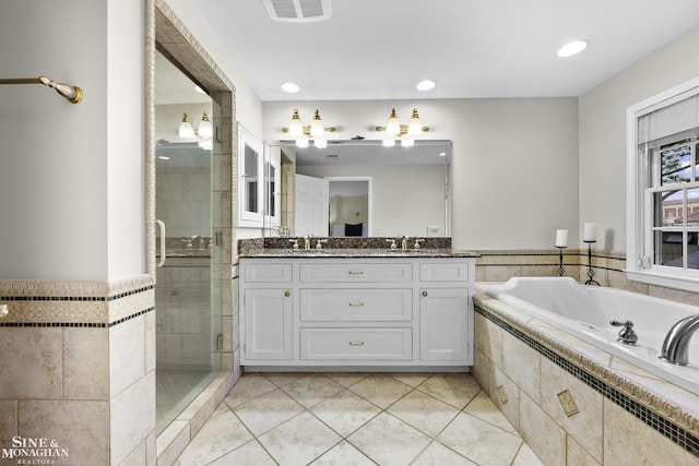 388 Lincoln Rd, Grosse Pointe, MI 48230 - full bath with double vanity, a bath, a stall shower, tile patterned floors, and recessed lighting