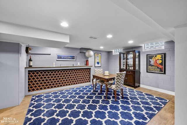 388 Lincoln Rd, Grosse Pointe, MI 48230 - office area with bar with sink, wood finished floors, concrete block wall, and recessed lighting