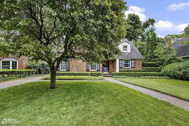 388 Lincoln Rd, Grosse Pointe, MI 48230 - obstructed view of property with brick siding and a front yard