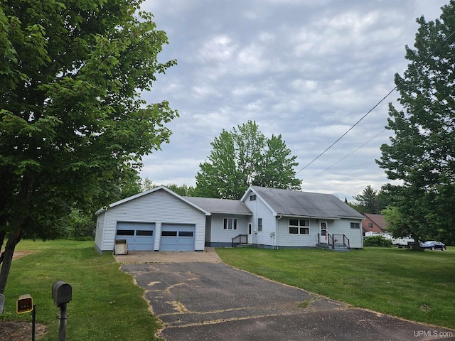 619 N 7th St, Ontonagon, MI 49953 - single story home with asphalt driveway, a garage, and a front lawn