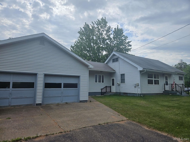 619 N 7th St, Ontonagon, MI 49953 - ranch-style home featuring driveway, an attached garage, and a front lawn
