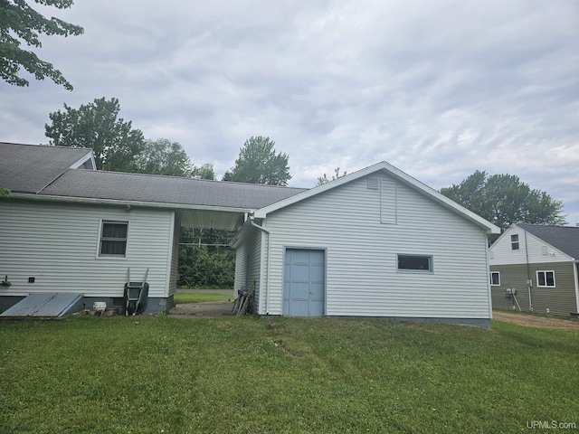 619 N 7th St, Ontonagon, MI 49953 - back of house featuring a yard and an attached garage