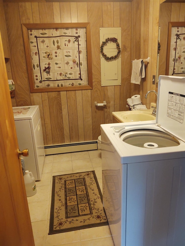 3601 Huckleberry Trl, Farwell, MI 48622 - washroom with a baseboard heating unit, washer and clothes dryer, wooden walls, and light tile patterned floors
