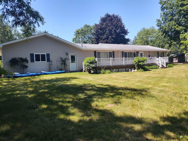 3601 Huckleberry Trl, Farwell, MI 48622 - back of property featuring a yard and a wooden deck