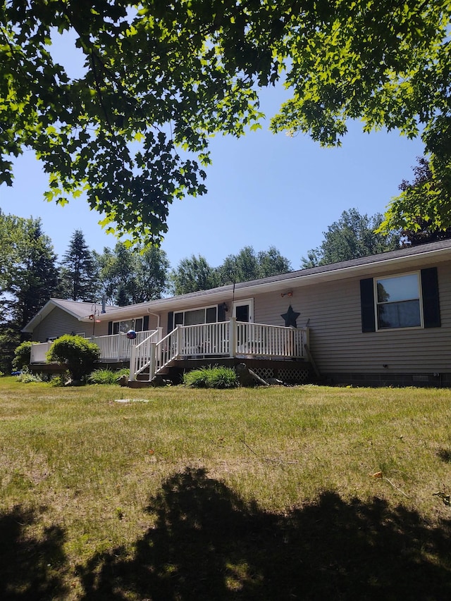 3601 Huckleberry Trl, Farwell, MI 48622 - back of property featuring a lawn and a wooden deck