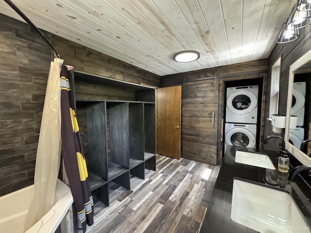 1801 Plymouth Mine Rd, Wakefield, MI 49968 - washroom featuring stacked washer / dryer, wood finished floors, wood ceiling, wooden walls, and a barn door