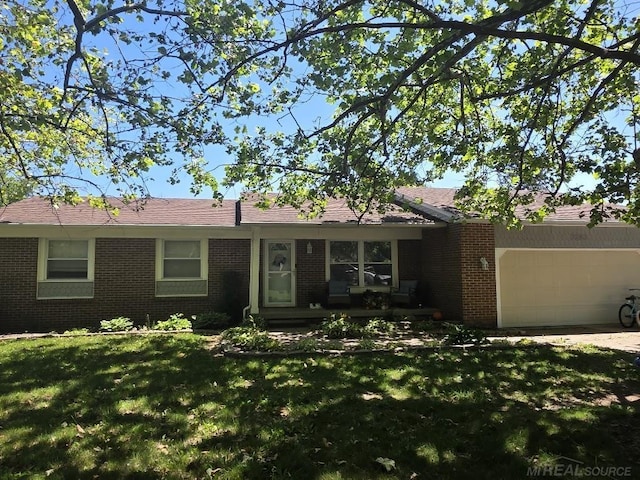7283 S Fork Dr, Swan Creek, MI 48473 - ranch-style home featuring brick siding, an attached garage, and a front lawn