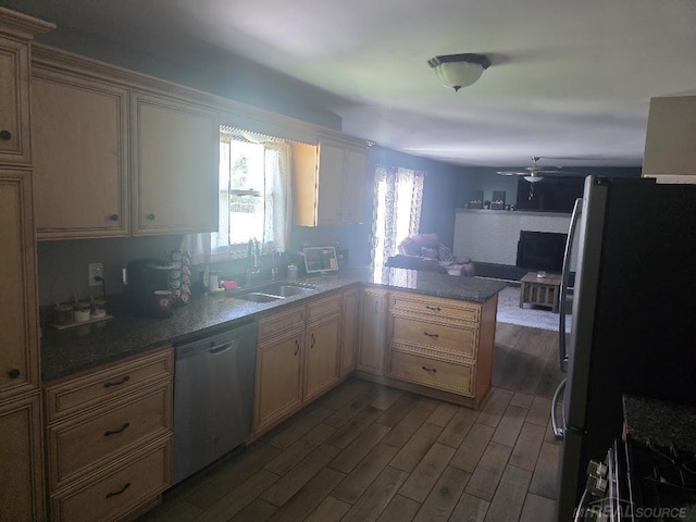 7283 S Fork Dr, Swan Creek, MI 48473 - kitchen with appliances with stainless steel finishes, dark wood-style floors, a peninsula, a ceiling fan, and open floor plan