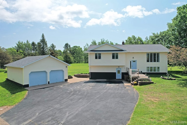 21805 Number 9 Rd, Hancock, MI 49930 - split foyer home featuring a detached garage, an outdoor structure, a front yard, and view of scattered trees