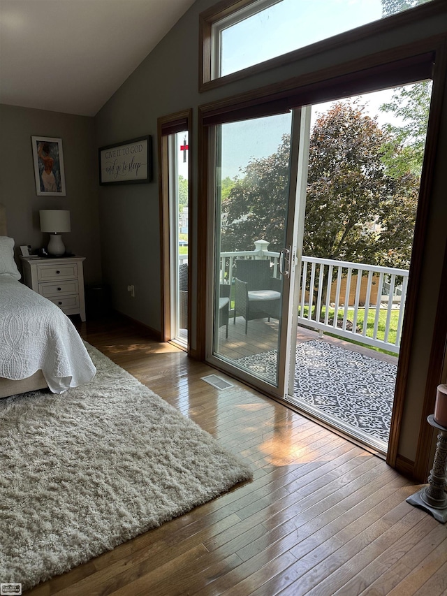 2100 Michigan St, Algonac, MI 48001 - bedroom with lofted ceiling, access to exterior, and hardwood / wood-style floors