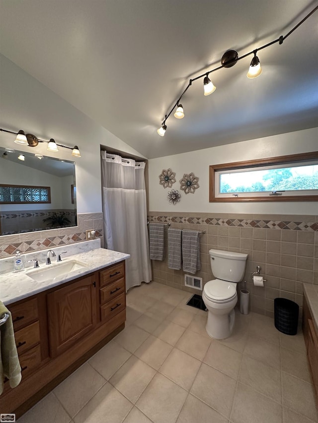2100 Michigan St, Algonac, MI 48001 - bathroom featuring tile walls, tile patterned flooring, vanity, wainscoting, and vaulted ceiling
