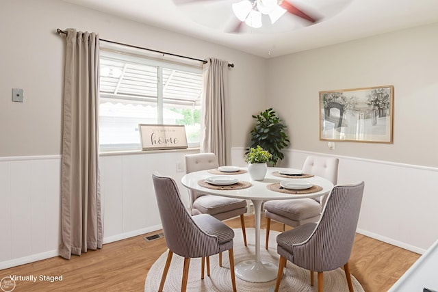 4444 Martin Rd, Warren, MI 48092 - dining space with light wood-style floors, ceiling fan, and wainscoting