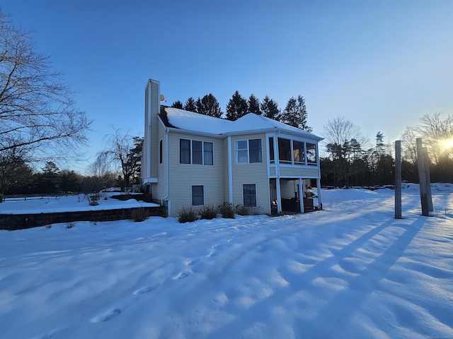 11639 State Rd, Nunica, MI 49448 - view of front of house featuring a chimney and a sunroom