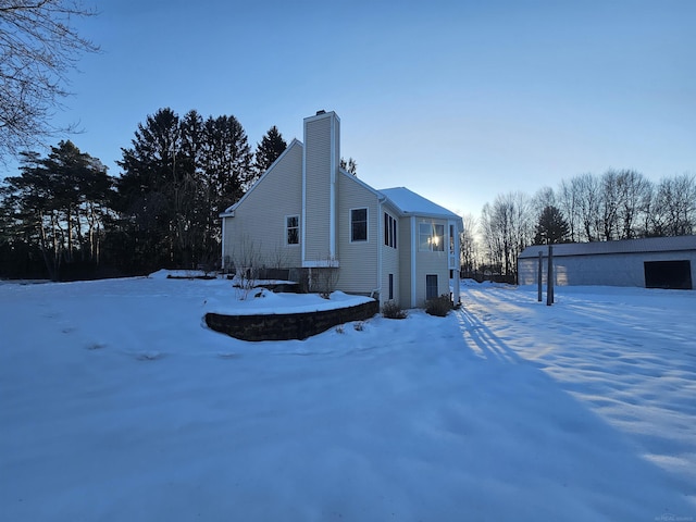 11639 State Rd, Nunica, MI 49448 - view of snowy exterior featuring a chimney