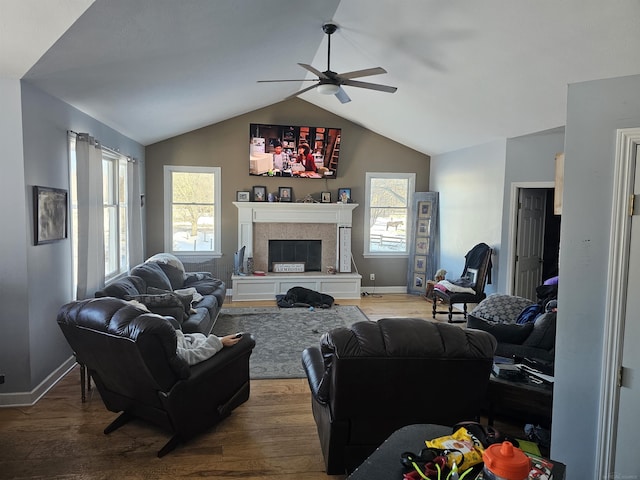 11639 State Rd, Nunica, MI 49448 - living room with a ceiling fan, wood finished floors, plenty of natural light, vaulted ceiling, and a tile fireplace
