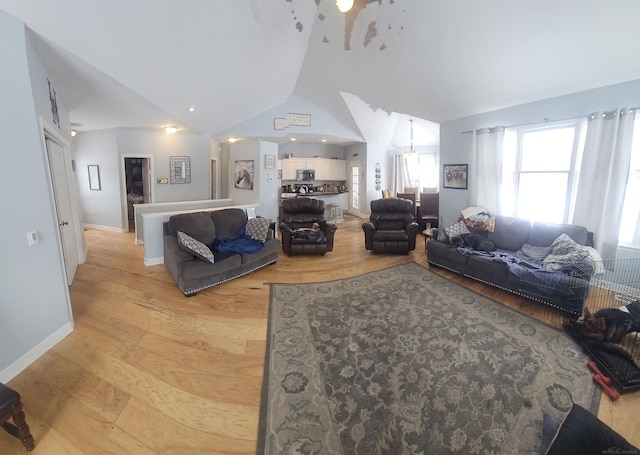 11639 State Rd, Nunica, MI 49448 - living room with lofted ceiling and light wood-style floors