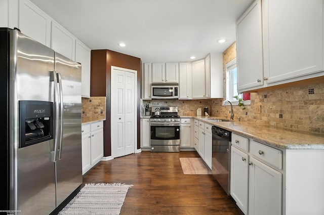 31222 Settlers Way Dr, Flat Rock, MI 48134 - kitchen with appliances with stainless steel finishes, dark wood-style floors, white cabinets, and recessed lighting