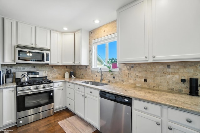 31222 Settlers Way Dr, Flat Rock, MI 48134 - kitchen featuring stainless steel appliances, white cabinetry, dark wood finished floors, tasteful backsplash, and recessed lighting