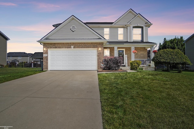 31222 Settlers Way Dr, Flat Rock, MI 48134 - view of front of home with a porch, driveway, a front lawn, an attached garage, and brick siding