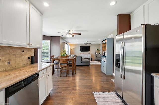 31222 Settlers Way Dr, Flat Rock, MI 48134 - kitchen featuring appliances with stainless steel finishes, ceiling fan, dark wood-style floors, tasteful backsplash, and white cabinets