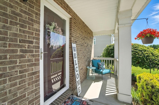 31222 Settlers Way Dr, Flat Rock, MI 48134 - view of exterior entry with covered porch and brick siding