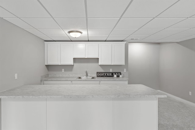 2233 Chase Dr Unit 105, Howell, MI 48855 - kitchen with a drop ceiling, white cabinets, light carpet, and light countertops