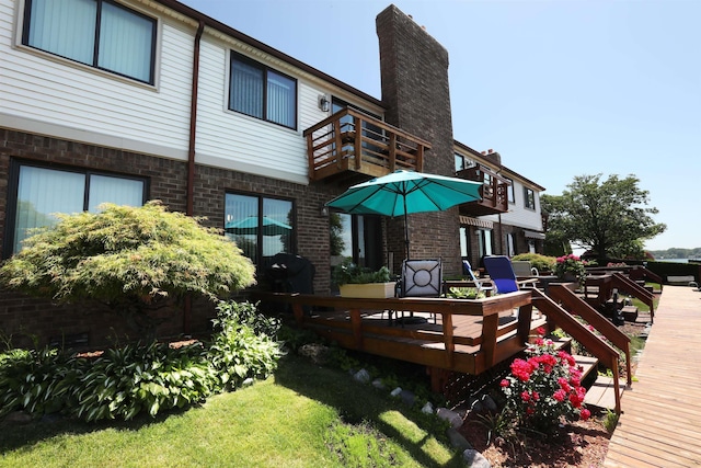 129 Cherryl Ln, Algonac, MI 48001 - back of property featuring a balcony, brick siding, and a deck