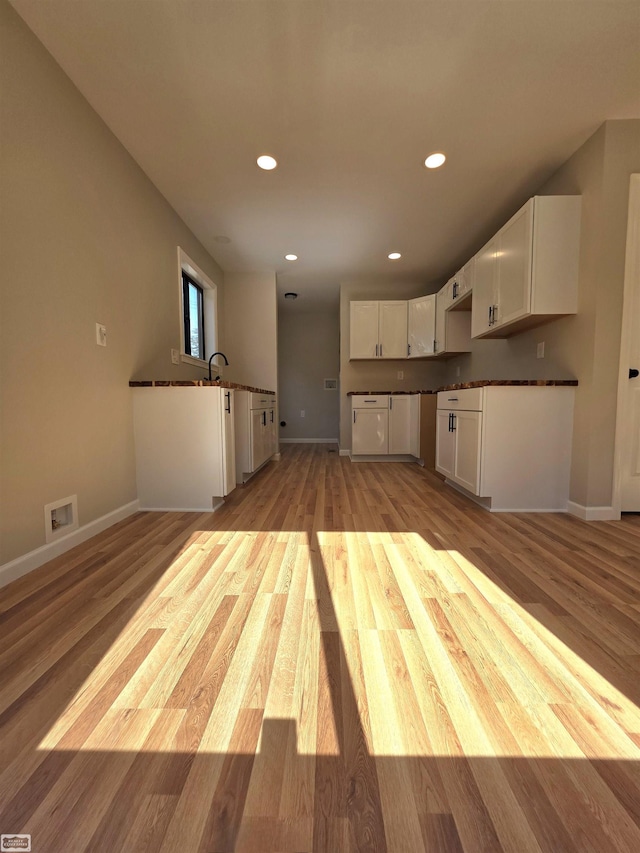 1329 Vermont Rd, Marysville, MI 48040 - kitchen featuring white cabinets, recessed lighting, light wood-type flooring, and dark countertops