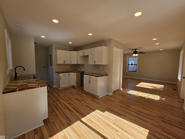 1329 Vermont Rd, Marysville, MI 48040 - kitchen with a ceiling fan, wood finished floors, recessed lighting, white cabinets, and dark countertops