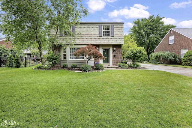 1344 Torrey Rd, Grosse Pointe Woods, MI 48236 - colonial home featuring mansard roof, brick siding, and driveway