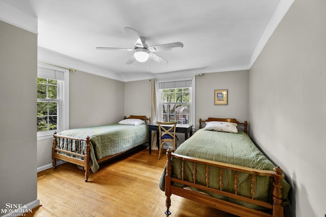 1344 Torrey Rd, Grosse Pointe Woods, MI 48236 - bedroom with multiple windows, light wood-style floors, and a ceiling fan