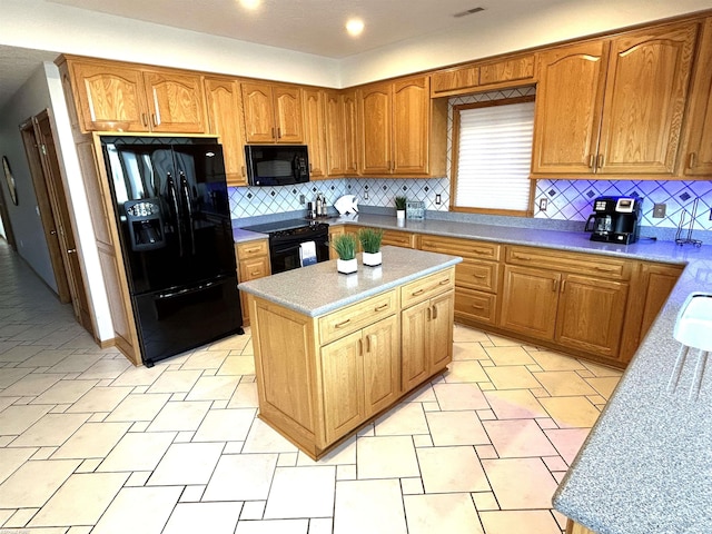 10125 Saint John Dr, Algonac, MI 48001 - kitchen with black appliances, decorative backsplash, light countertops, a kitchen island, and brown cabinets