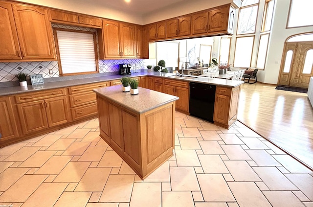10125 Saint John Dr, Algonac, MI 48001 - kitchen with black dishwasher, backsplash, a center island, and brown cabinetry