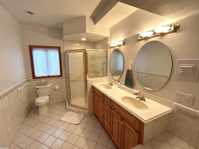 10125 Saint John Dr, Algonac, MI 48001 - bathroom with tile patterned flooring, tile walls, a stall shower, double vanity, and a wainscoted wall