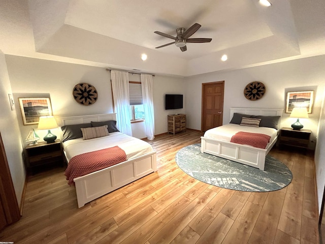 10125 Saint John Dr, Algonac, MI 48001 - bedroom featuring a raised ceiling, light wood-style floors, a ceiling fan, and recessed lighting