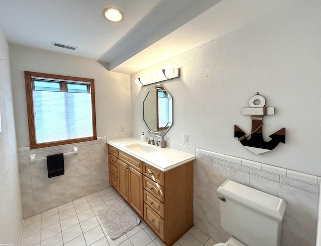 10125 Saint John Dr, Algonac, MI 48001 - bathroom with tile walls, vanity, tile patterned flooring, and a wainscoted wall