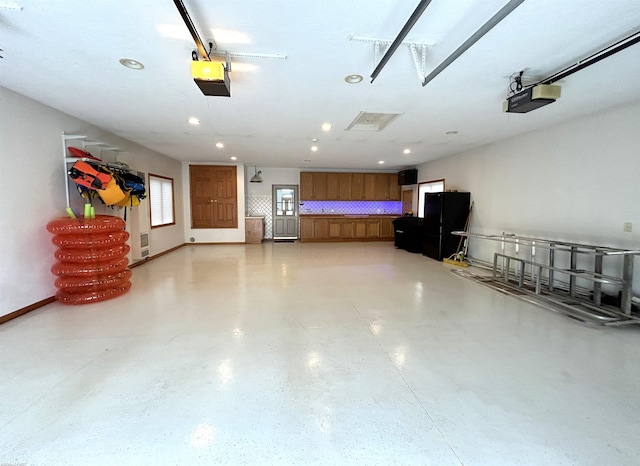 10125 Saint John Dr, Algonac, MI 48001 - garage with a garage door opener, recessed lighting, and freestanding refrigerator