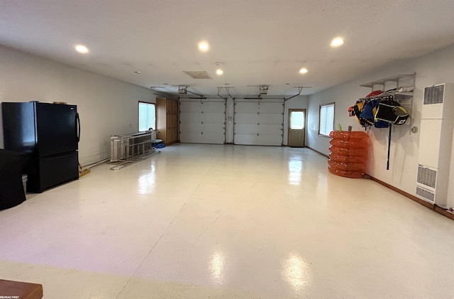 10125 Saint John Dr, Algonac, MI 48001 - garage featuring freestanding refrigerator, a heating unit, and recessed lighting