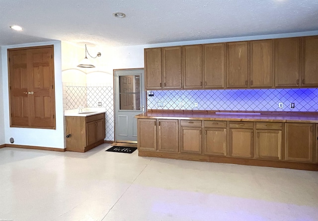 10125 Saint John Dr, Algonac, MI 48001 - kitchen with brown cabinets, tasteful backsplash, and light flooring