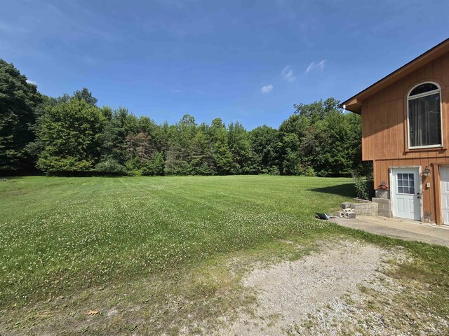 55305 Fairchild Rd, Macomb, MI 48042 - view of green lawn featuring a wooded view
