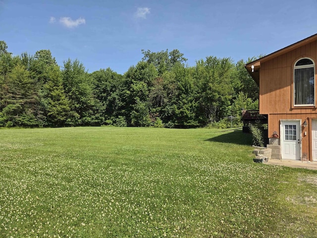 55305 Fairchild Rd, Macomb, MI 48042 - view of grassy yard with a wooden deck and a wooded view