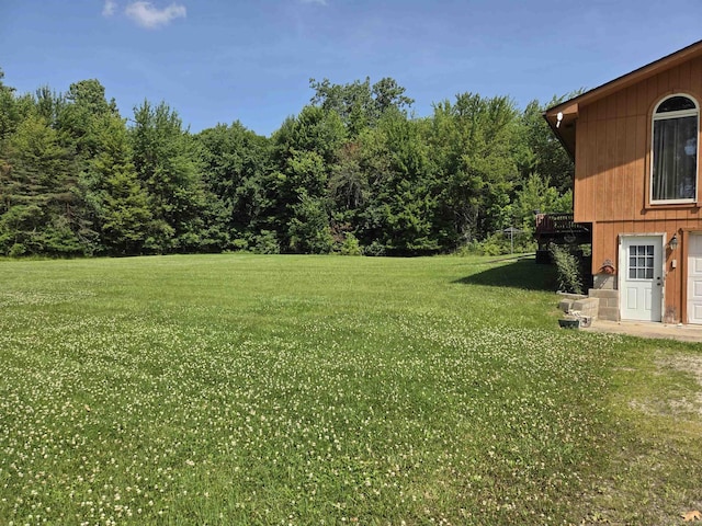 55305 Fairchild Rd, Macomb, MI 48042 - view of grassy yard featuring a deck and a forest view